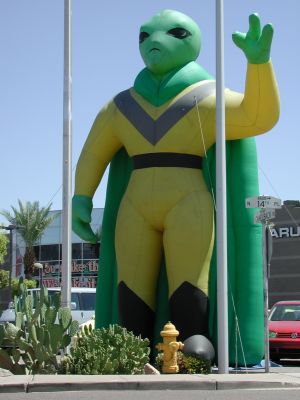 Giant green alien sells Subarus.
