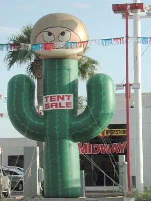 Giant helmet-wearing cactus sells Nissans.
